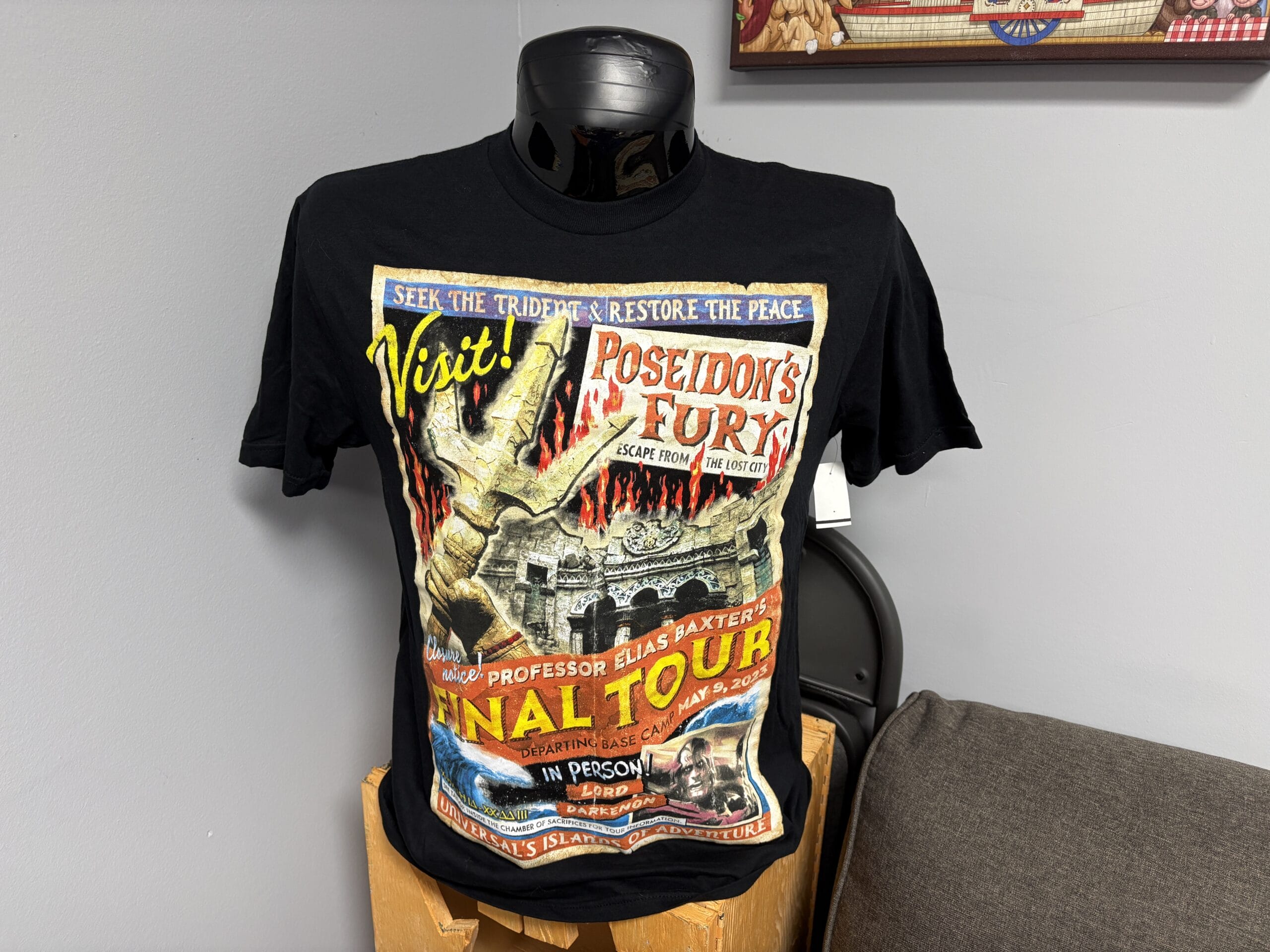 Black T-shirt on mannequin featuring a colorful "Poseidon's Fury" tour graphic, part of the WDWNT Summer Auction.