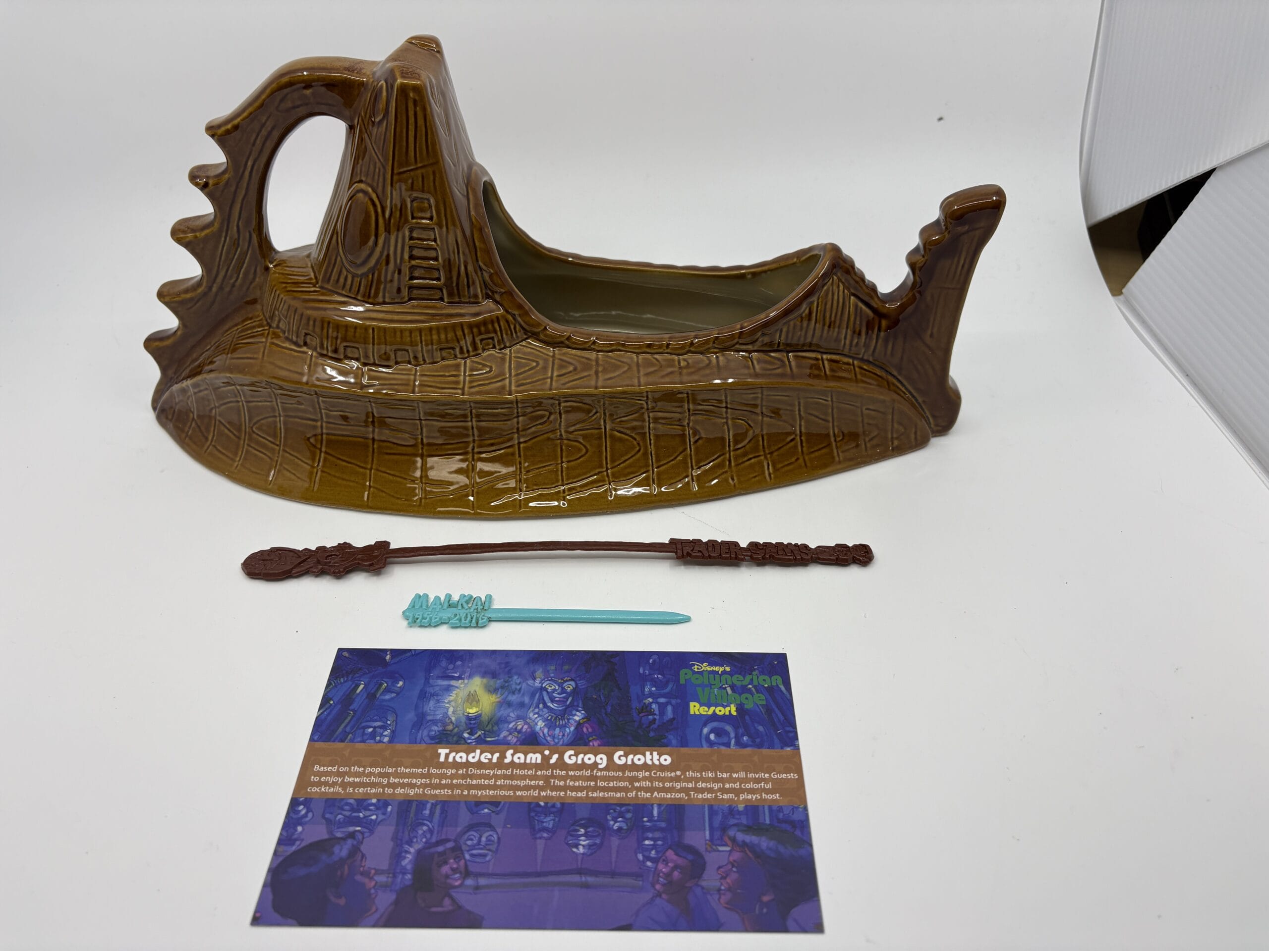 A brown Nautilus-shaped mug, blue swizzle stick, and info card from the WDWNT Summer Auction on a white background.