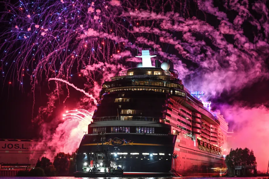 The Disney Destiny Cruise Ship dazzles at night as fireworks and smoke light up the sky in a stunning sea trials display.