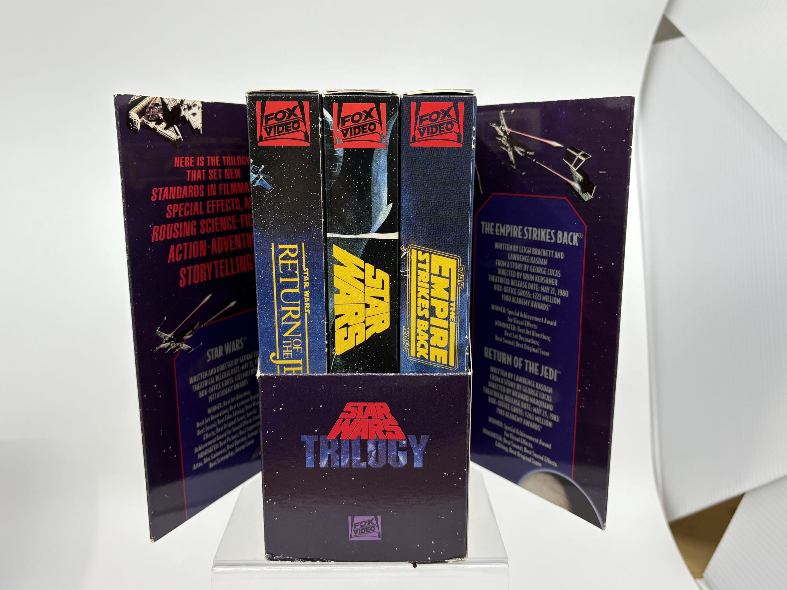 Three Star Wars VHS tapes in a trilogy box set, open to show titles—perfect for any WDWNT Summer Auction collector.