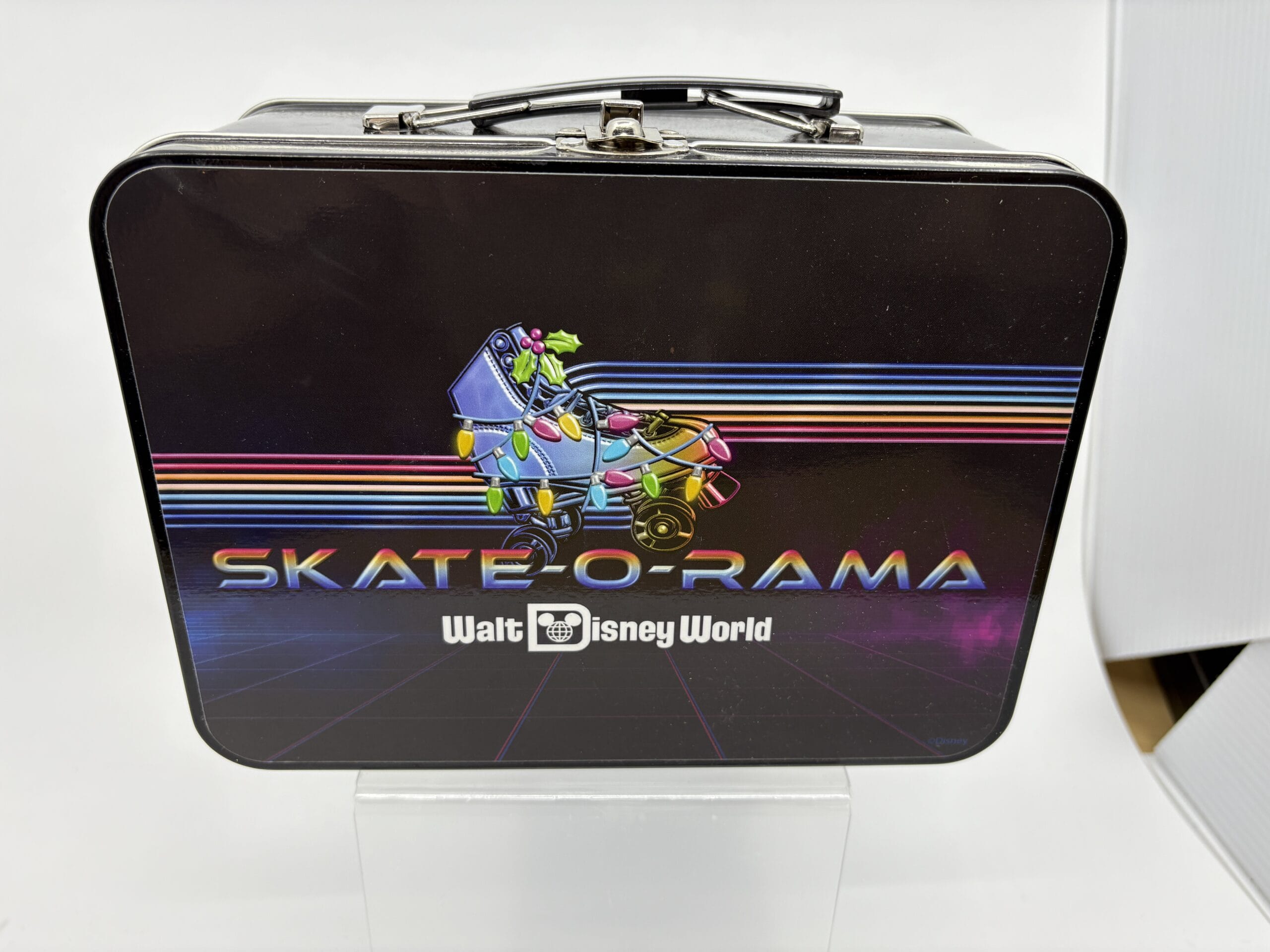 Rectangular lunchbox with "Skate-O-Rama Walt Disney World" and a neon dinosaur—featured in the wdwnt summer auction.
