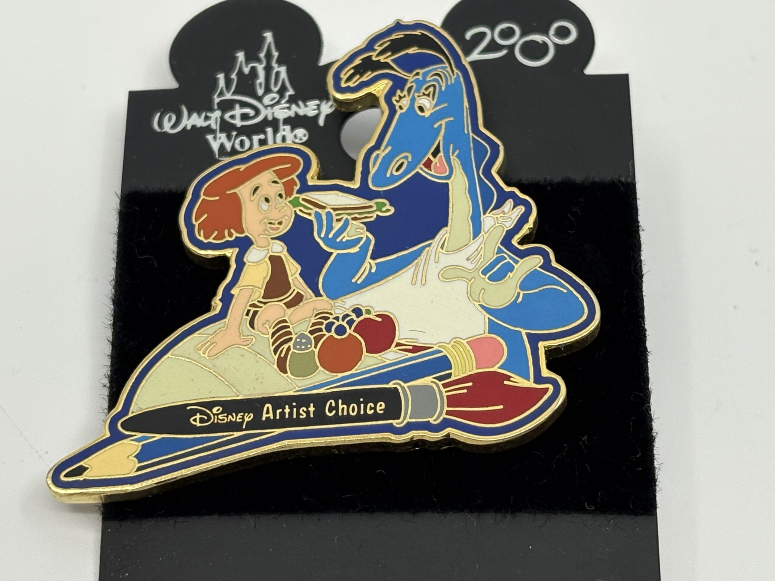 Disney pin features a girl and blue dragon on paintbrushes, "Disney Artist Choice," from the wdwnt summer auction.