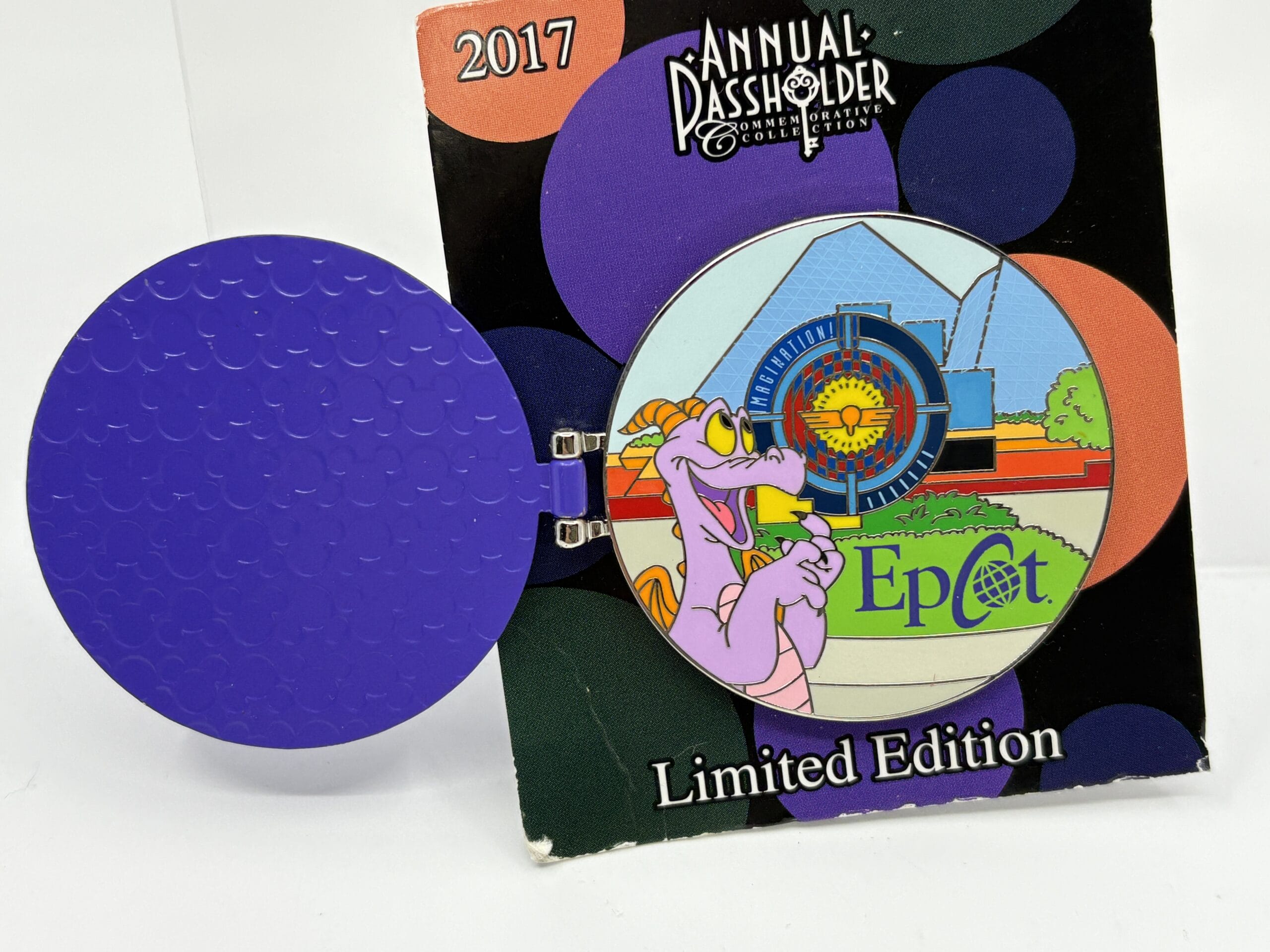A limited edition 2017 Epcot pin, from the wdwnt summer auction, featuring Figment and Spaceship Earth.