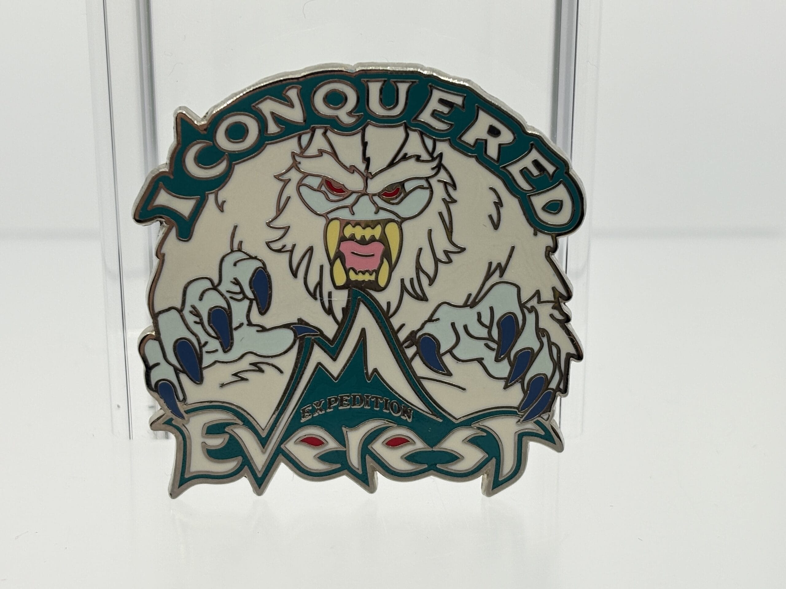 A pin with a yeti and "I Conquered Expedition Everest" above stylized mountains from the WDWNT summer auction.