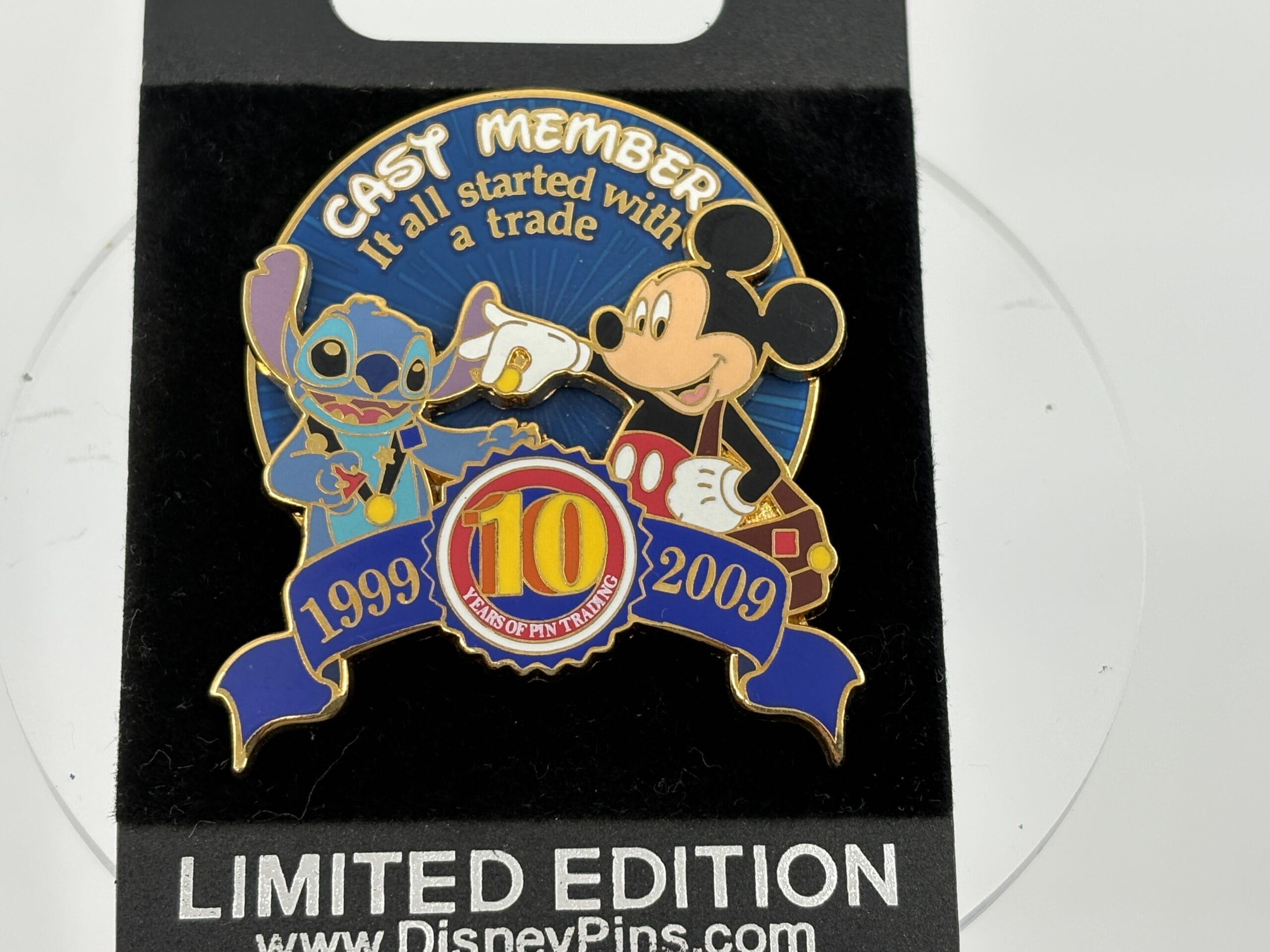 Disney pin featuring Stitch and Mickey Mouse fist-bumping, celebrating 10 years of pin trading at the wdwnt summer auction.