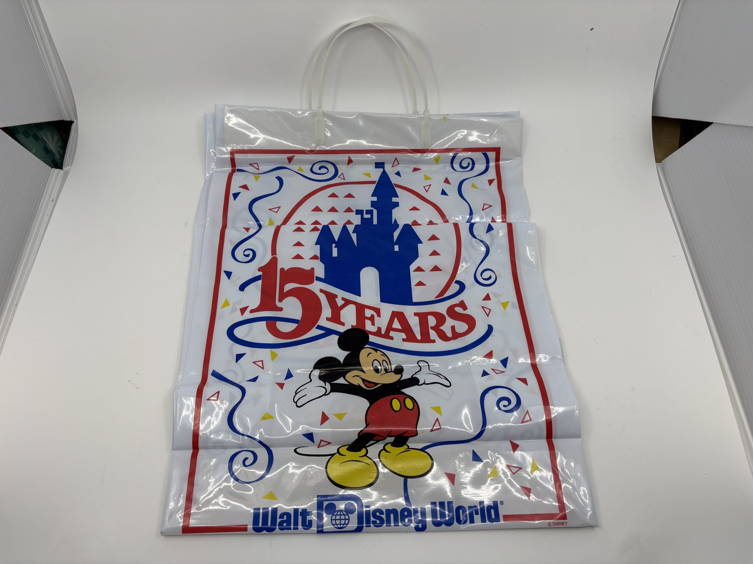 A Disney World plastic bag with Mickey Mouse, a castle, and "15 Years" text from the wdwnt summer auction.